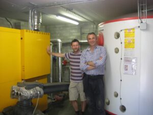 Tim Reed and Kevin Lindegaard with a biomass boiler