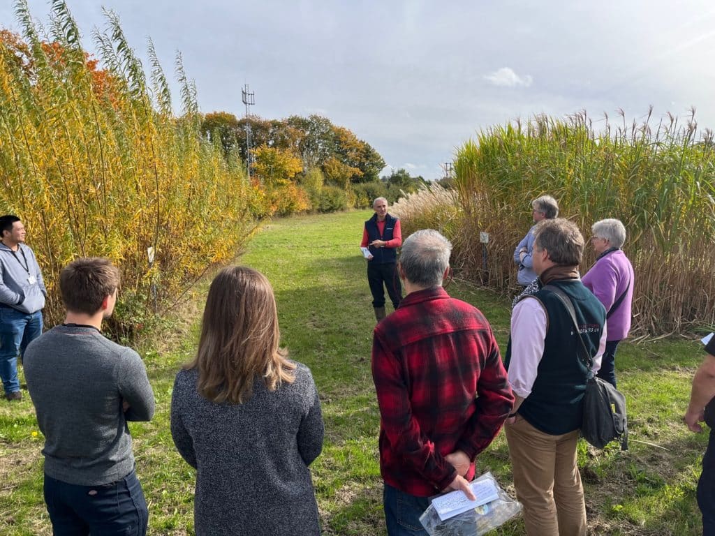 Kevin Lindegaard talking to CHCx3 project colleagues next to willow and miscanthus trials at a meeting at NIAB, Huntingdon in January 2025. 